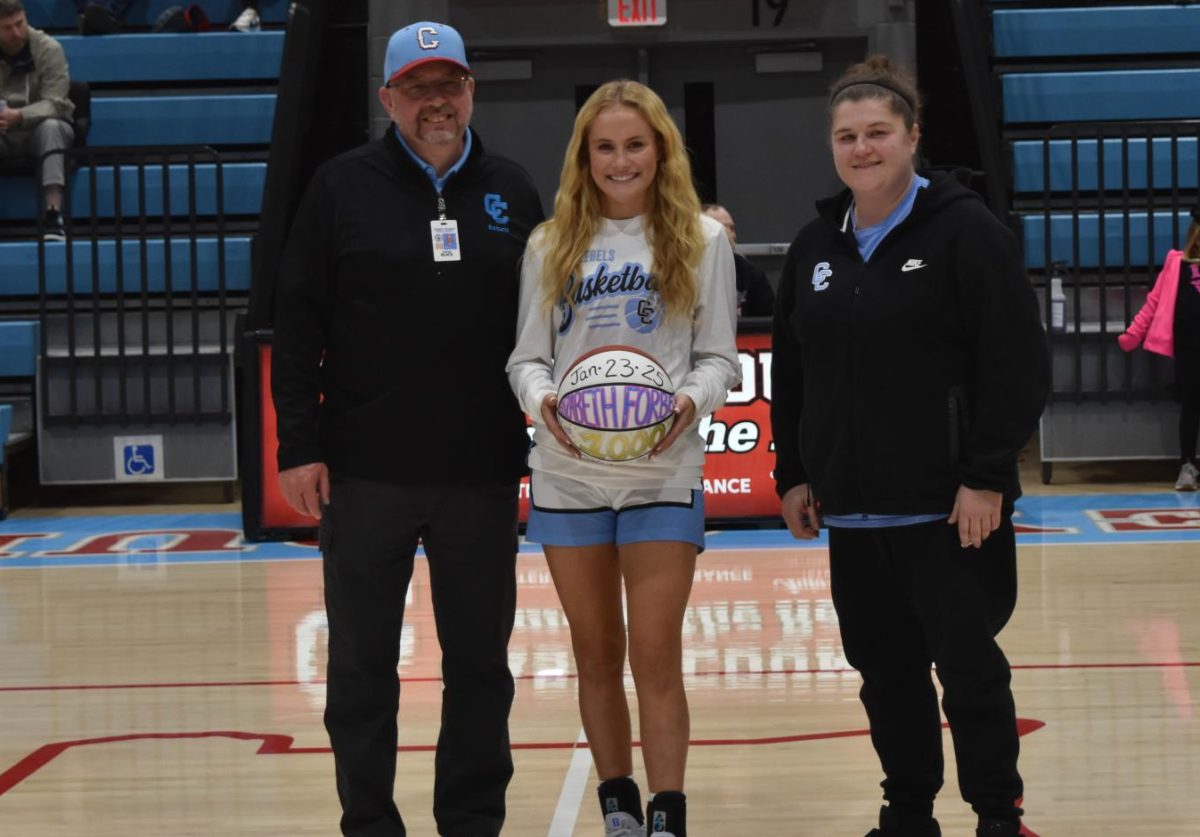 Junior guard Liz Forbes (middle) was honored prior to the Lady Rebels' home game against Garrard County. She is joined by athletics director Victor Black (left) and head coach Lauren Hatter.